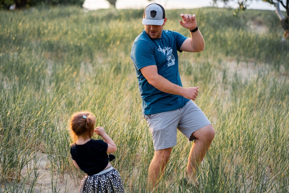 Father and Daughter Dancing in a field